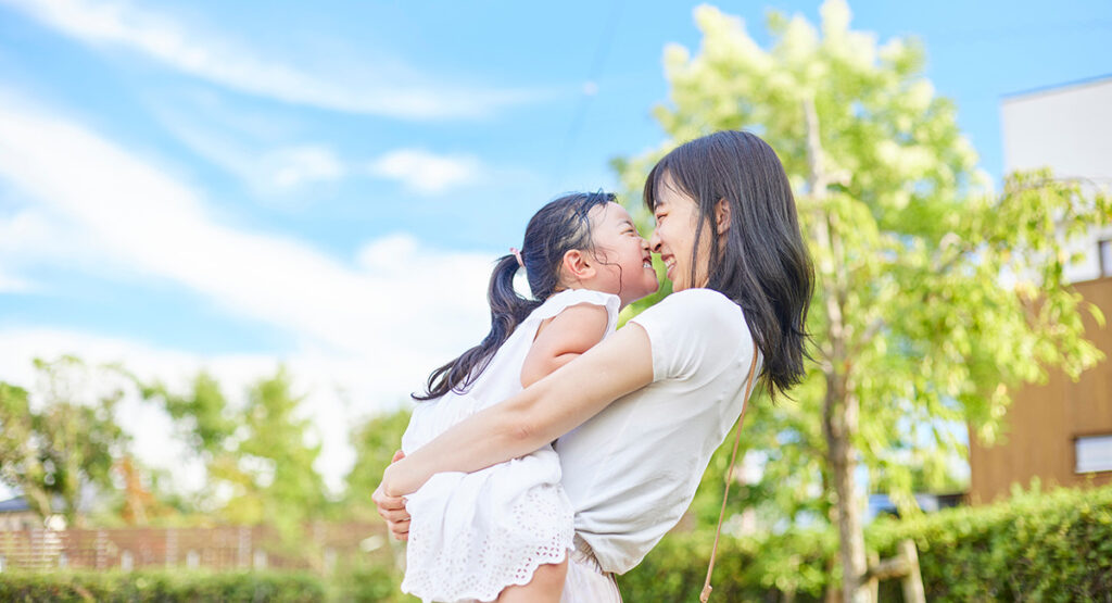 子どもと笑顔で抱き合っている様子